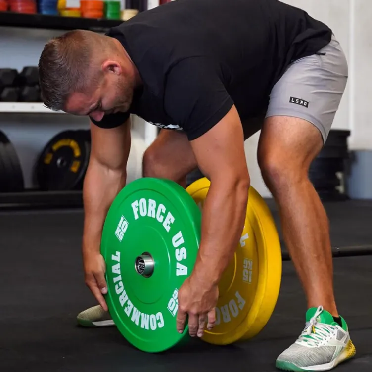 Bumper plates Force USA en caoutchouc colorés avec code couleur IWF de 5 à 25 kg
